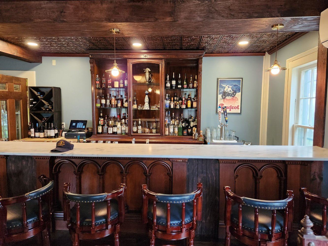 Deming Tavern bar with arched back bar and brass details