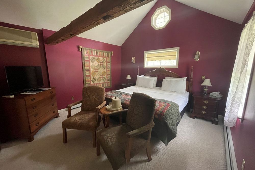 Arbor View: burgundy walls, exposed wood beams, octagonal window