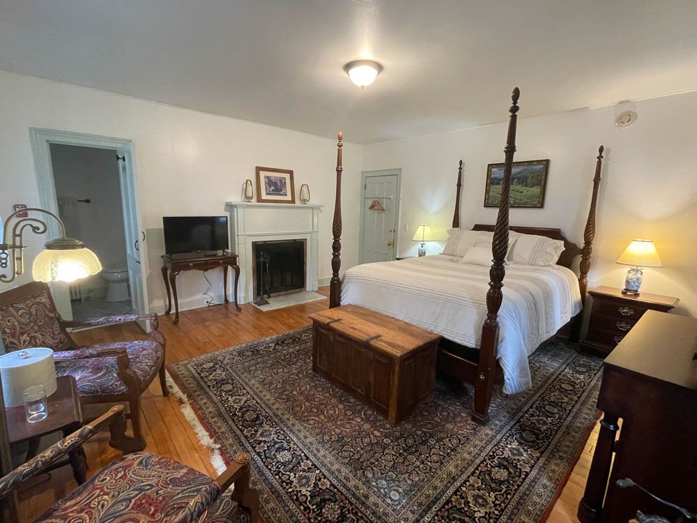 Remember Baker's Room: four-poster bed with white fireplace